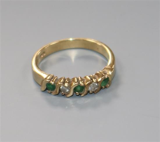 A modern 9ct gold, emerald and diamond five stone half hoop ring, size K.